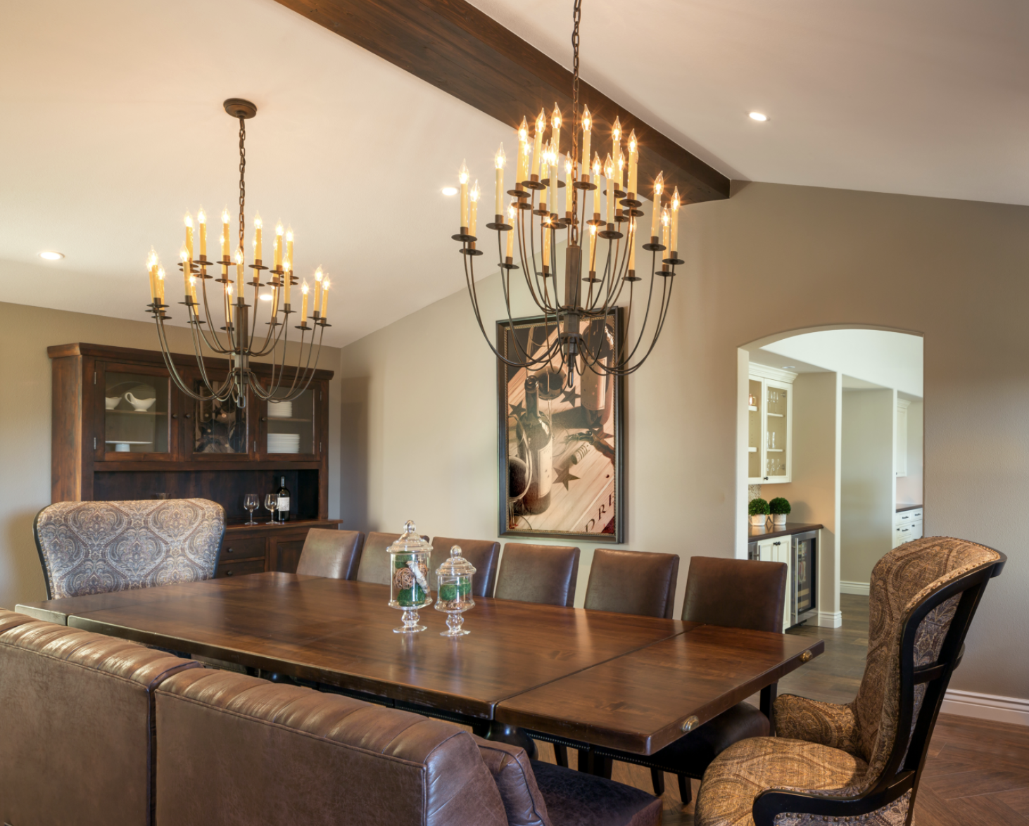 rustic traditional dining room dual chandelier exposed beam walnut table arched doorways bay area renovation
